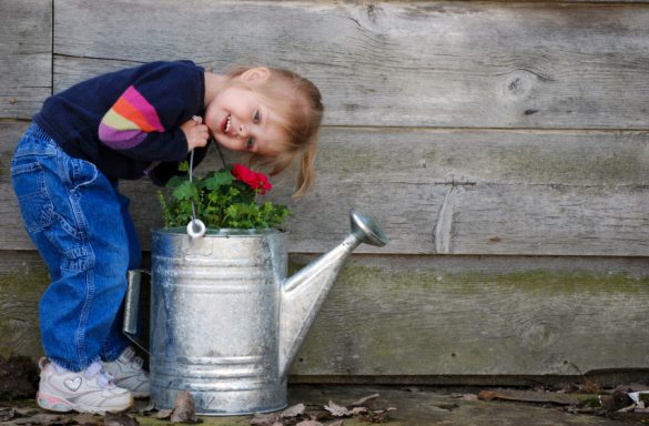 Young lady playing with a watering can